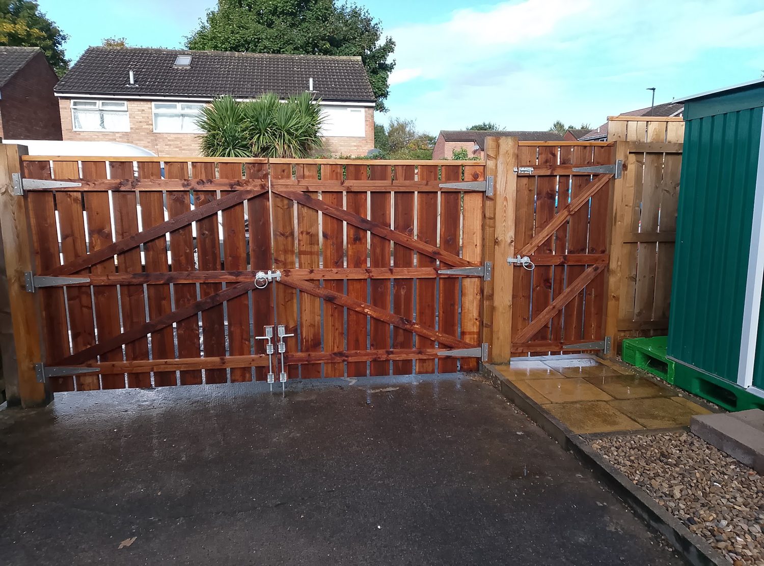 A new pair of tall timber gates with a matching side gate