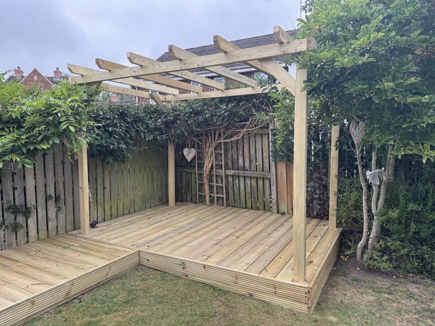 A corner deck with a timber pergola